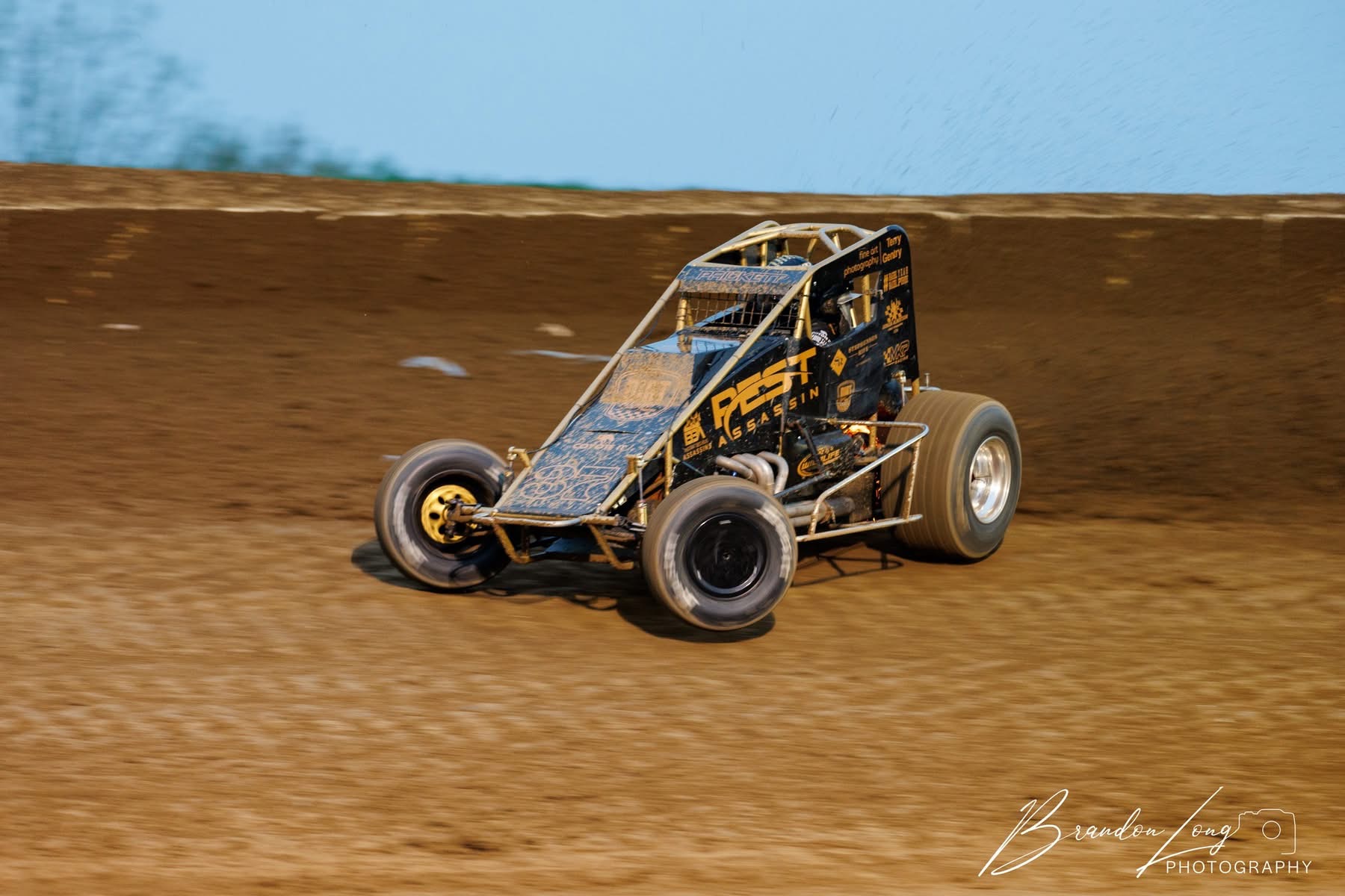 No. 37 sprint car on track under blue skies